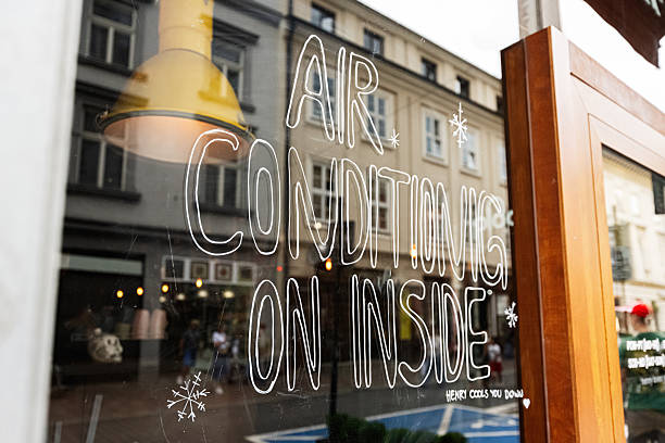 istock Glass storefront in Krakow advertising air conditioning inside during summer 2230996919