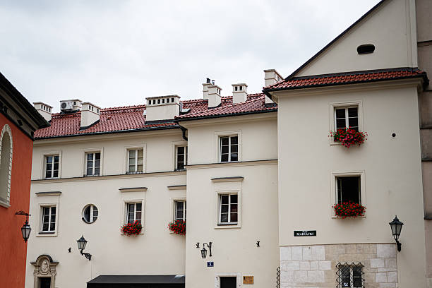 Charming historic building facade adorned with flower boxes in Krakow, Poland