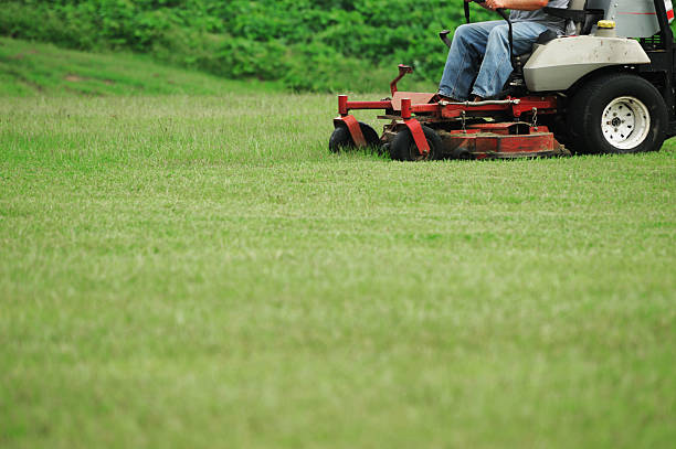 istock outdoor worker working on mowing the lawn 2230997702