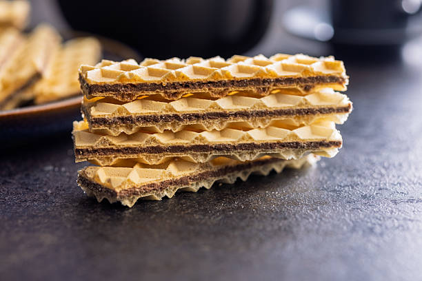 istock Sweet crispy wafers on black table. 2230997893