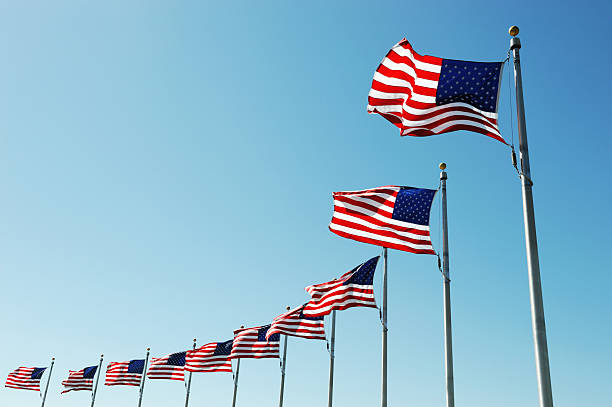 istock USA flags in a row waving in the wind 2230999455