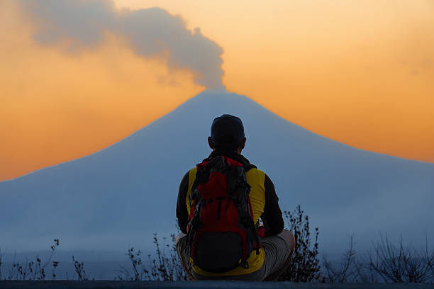 istock Hiker watching popocatepetl volcano erupting at sunset 2231001502
