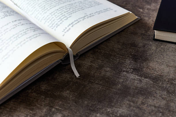 istock Pages of a book open on a textured surface with another book nearby 2231004655