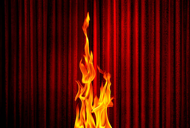 Beautiful flame out of fire-eater's mouth. On black background.