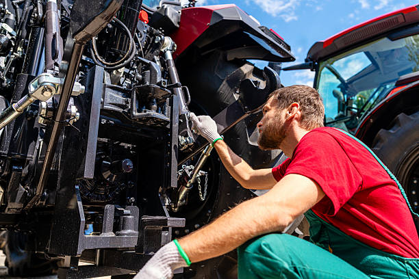 istock Agricultural machinery mechanic checking farm tractor 2231010201