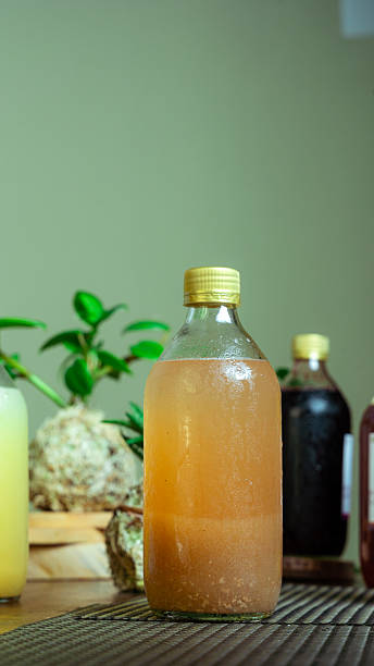 istock Refreshing kombucha fermenting in glass bottle on table 2231011682