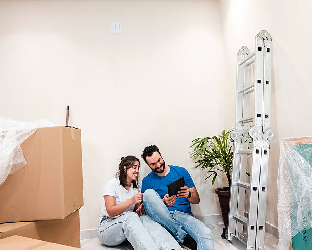 istock Couple resting among moving boxes in new home 2231016494