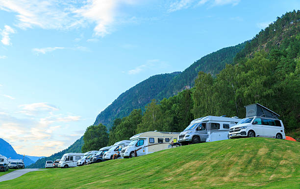 Motorhome parked on grass during sunset in summer time