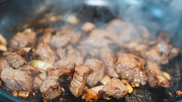 istock Cubed Beef Sizzling in Pan with Onions and Garlic 2231018463