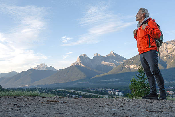istock Mature man hikes along mountain path at sunrise 2231019723