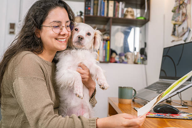 istock Graphic designer working from home with her dog 2231021328