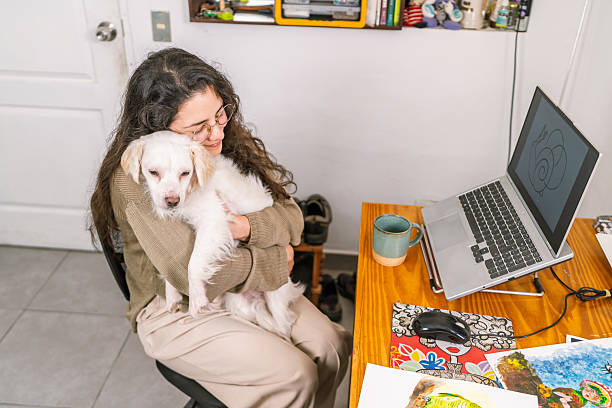 istock Graphic designer working from home with her dog 2231021330