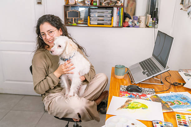 Graphic designer working from home with her dog