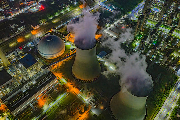 Night industrial landscape: smoke from factory chimneys. Environmental pollution.