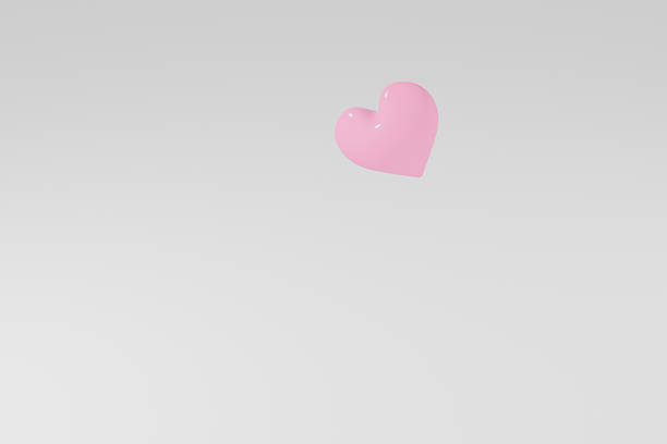 Red heart baloon on plain blue background