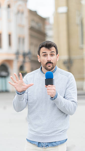 istock Man Speaking to Camera in Lively Urban Setting 2231023491