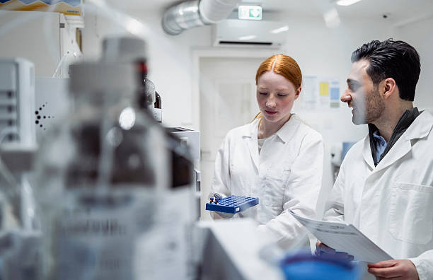 istock Young Female and Male Pharmacy Workers Collaborating in Bright Laboratory 2231025174