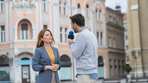 Candid moment during an interview in lively urban scene.