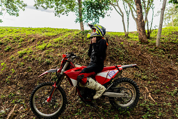 istock Female motocross rider getting ready on a forest trail 2231027394