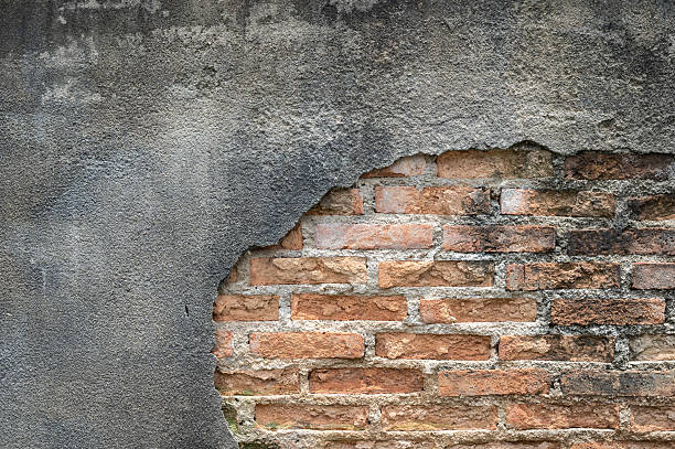 istock Close up of damaged cement wall with brick wall inside. 2231030944