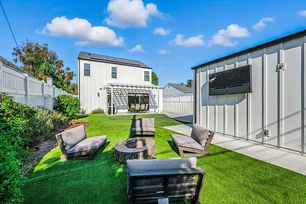 istock Modern backyard with seating and white house. 2231034015