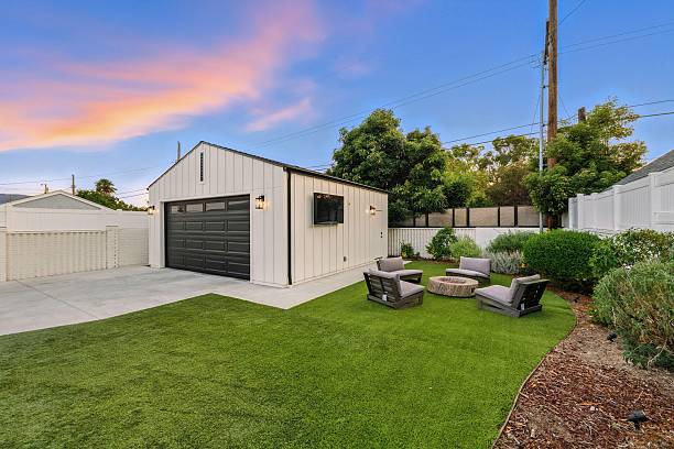 istock Modern backyard with garage and patio furniture. 2231034029