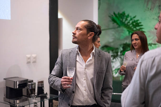 istock group of friends socializing while drinking champagne 2231040425
