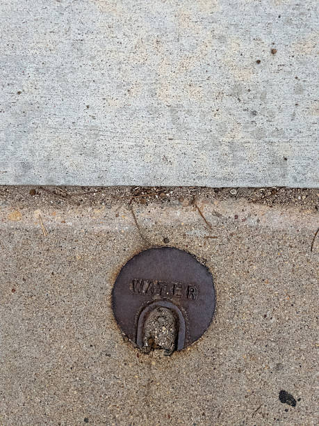 istock Water shut-off valve embedded in concrete sidewalk 2231041573