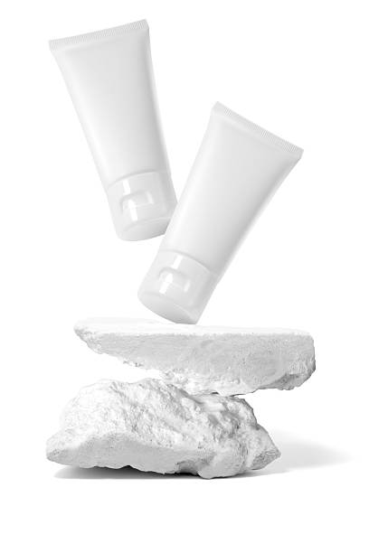 istock White plastic cream tube with stone for mockup isolated on white background. Selective Focus. 2231042740