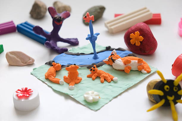 istock Child making crafts using natural dry plants, flowers, grass, leaves and use plastic corks, stones, plasticine, beads and paper. Back to school. Making diorama. Ideas for children's art 2231044403