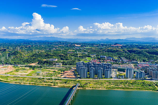 istock Blue sky and white clouds over a city river 2231049069