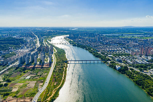 istock Blue sky and white clouds over a city river 2231049376