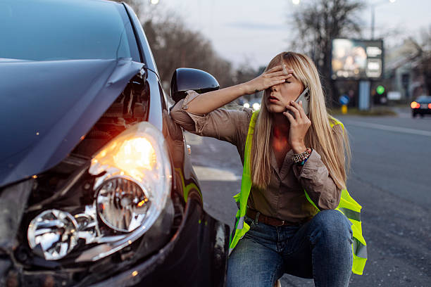 istock Woman Calling for Roadside Assistance After Car Accident 2231049467