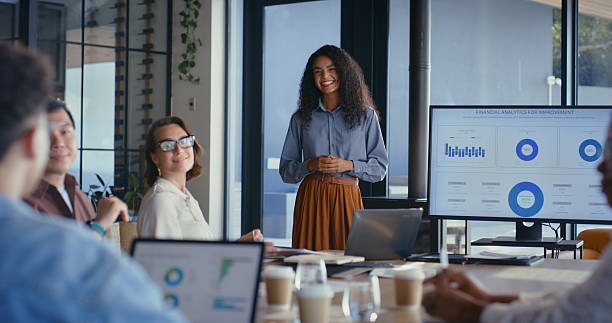 istock Businesswoman, team presentation and screen with chart for financial analytics for trading. Happy presenter, monitor or graphs for coaching, training and stock market investment with profit in office 2231053928