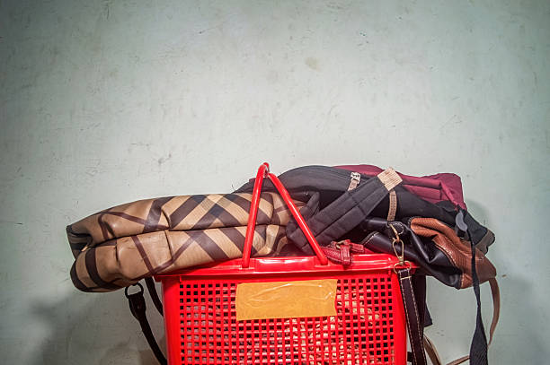 istock Various bags are piled in a red plastic basket, creating a cluttered yet organized storage solution. The bags showcase different styles and materials, highlighting variety 2231055061