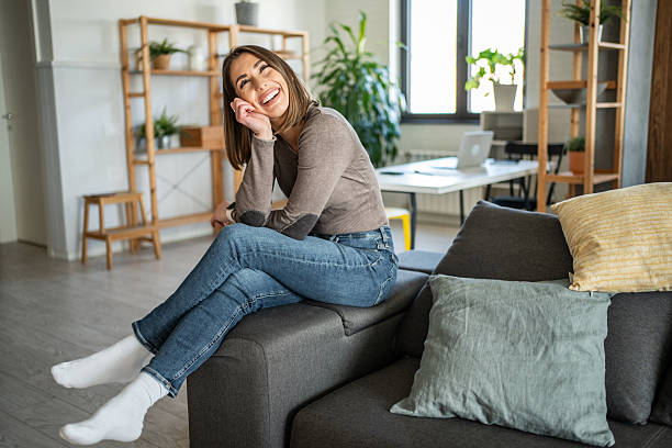 istock Serene woman relaxing on sofa, enjoying peaceful home atmosphere 2231055355