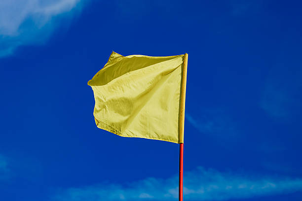 istock Yellow Flag Against Clear Blue Sky 2231056634