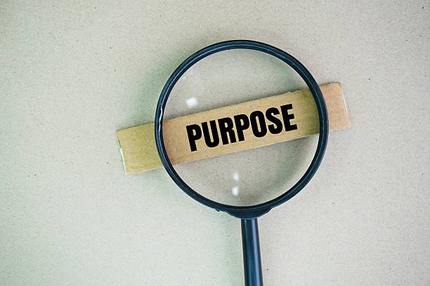 istock A magnifying glass with the word PURPOSE. the reason for which something is done or created or for which something exists. 2231062200