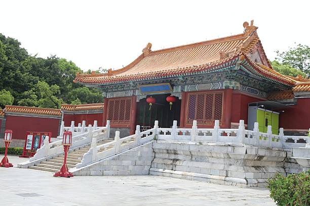 istock A red and white stone building with two steps, surrounded by green trees on the left side. 2231062534