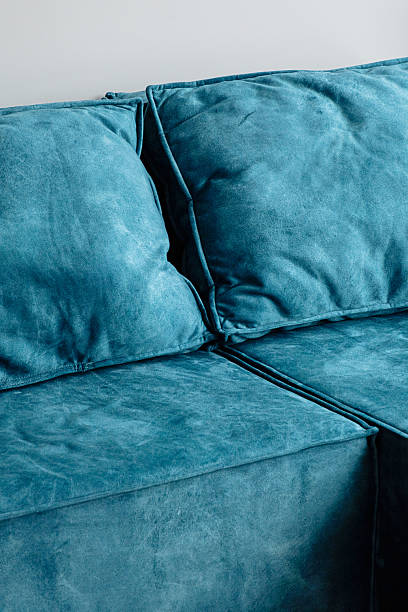 istock Close up view of blue suede sofa and cushions. 2231063466