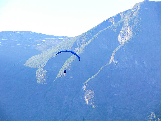 istock Paragliding adventure over misty mountains in Norway 2231063656