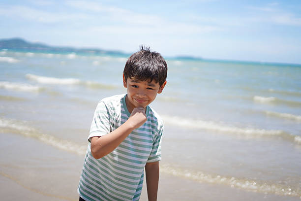 Moment when a boy looks happy at the beach