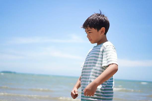 Moment when a boy looks happy at the beach
