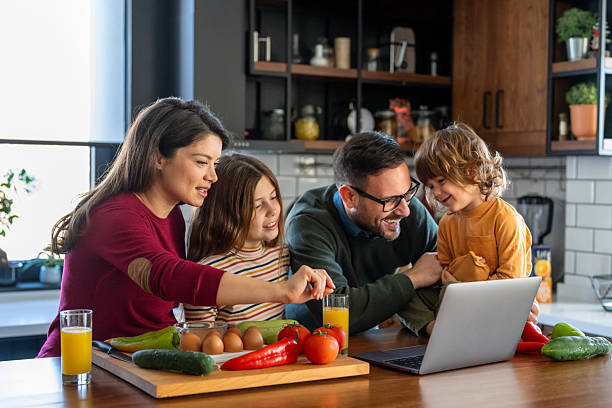 istock Parents and child relaxing at home with computer watching funny internet video, making online call 2231069089