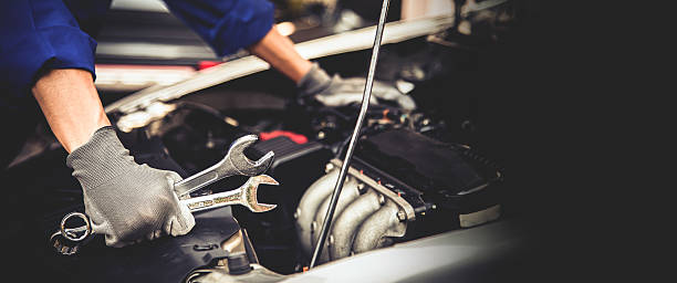 istock Car care maintenance and servicing, Close-up hand technician auto mechanic using the wrench to repairing change spare part car engine problem and car insurance service support. 2231069319