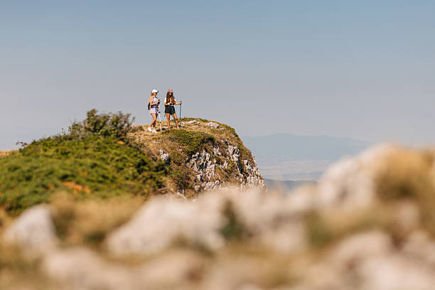 istock Two women hiking on rocky hill 2231072594