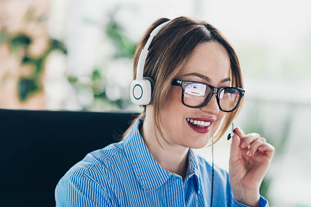 istock Young professional woman in office communicating through a headset and computer showcasing confidence and expertise 2231073136