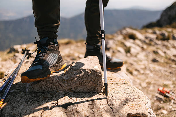 istock Close up of hiking boots with trekking pole 2231074302