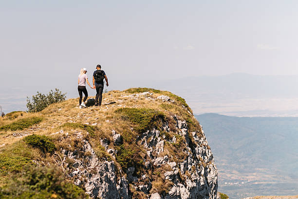 istock Couple holding hands on mountain cliff 2231074340