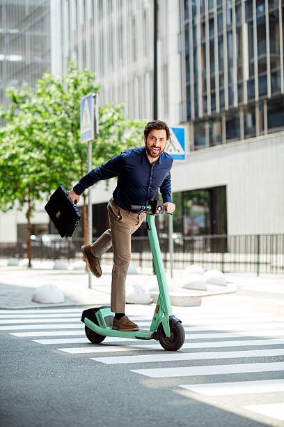istock Young professional riding an e-scooter in a business district during urban commuting on a bright day 2231077105